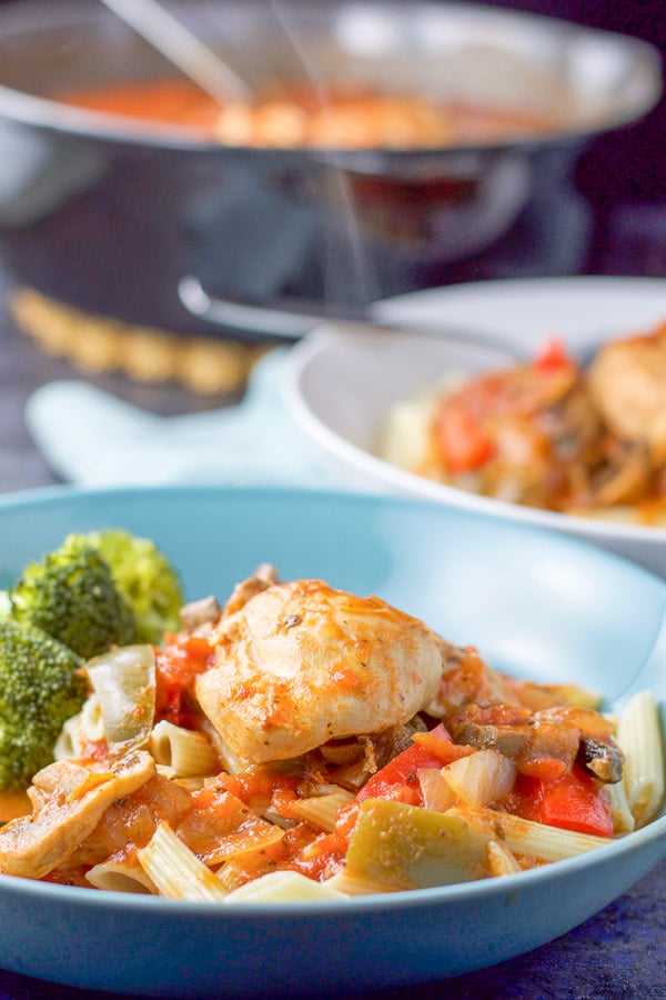 Instant pot chicken cacciatore in a bowl over gluten free pasta