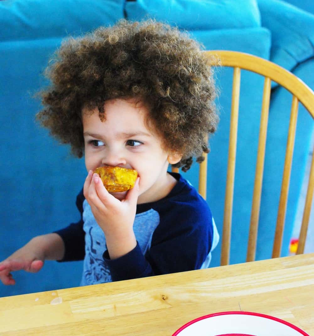 Child eating an easy pumpkin cinnamon roll