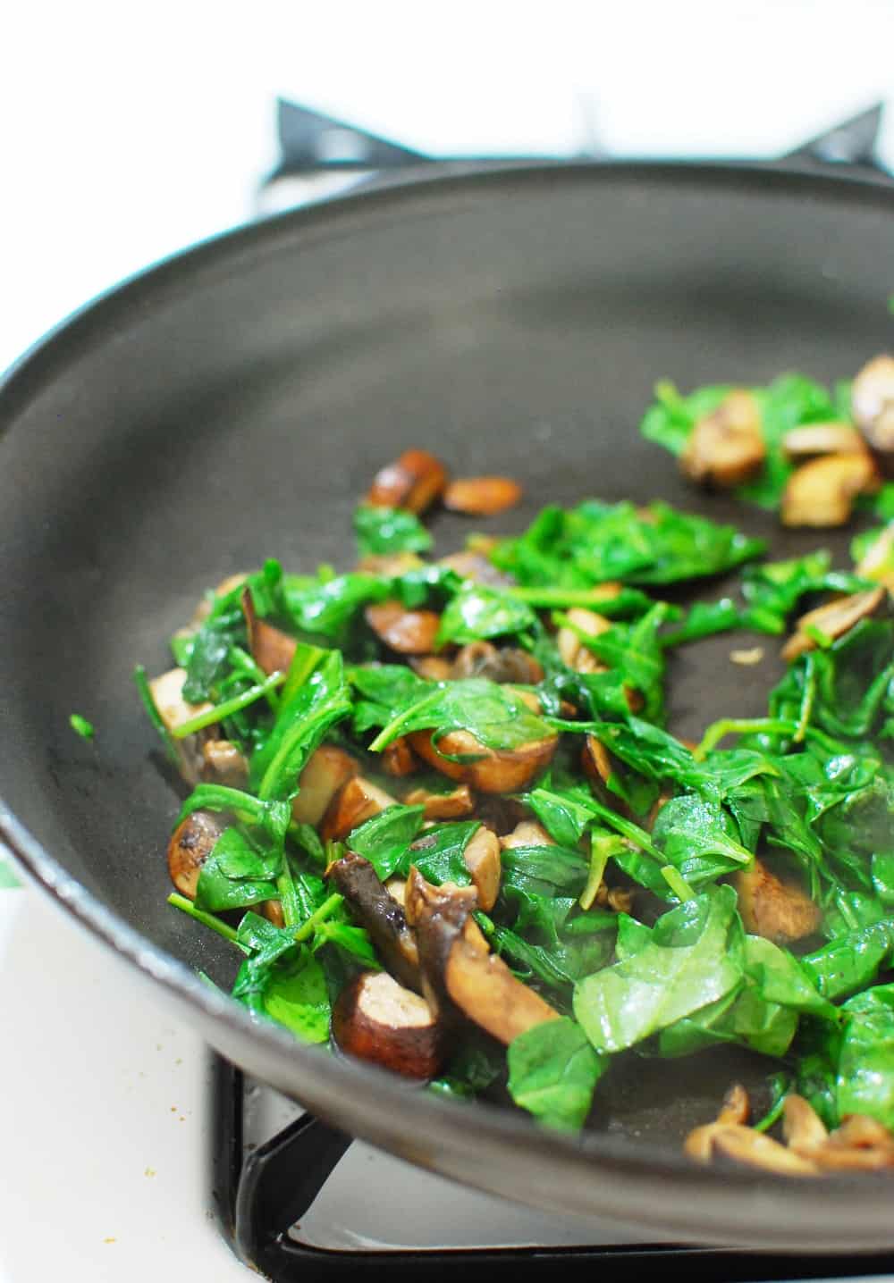 Spinach and mushrooms in a saute pan