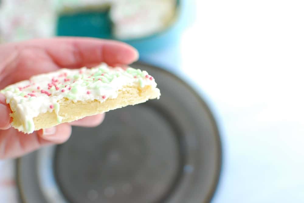 A hand holding up a dairy free sugar cookie bar