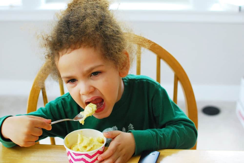 A young child eating homemade pineapple ice cream