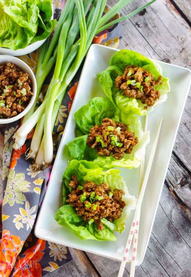 Dairy Free lettuce wrap appetizer on white tray next to green onions