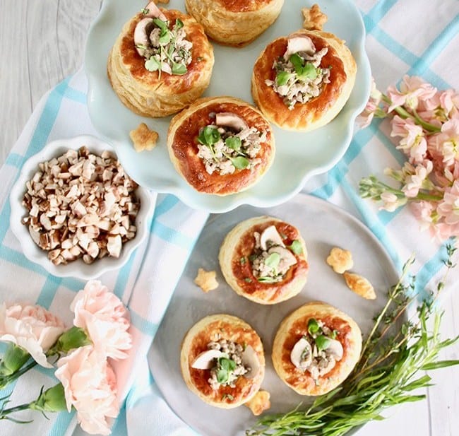 Dairy Free Mushroom Puff Pastry Cup Appetizer on plates on top of a striped towel