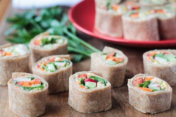 Dairy Free Tortilla Rollup Appetizer on a wooden countertop with green garnish