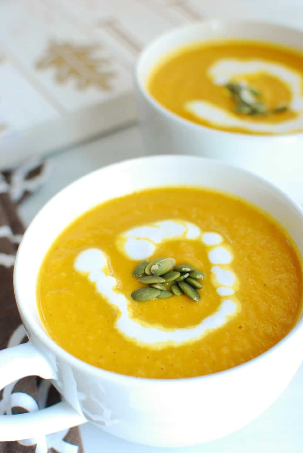 A large white mug full of pumpkin soup