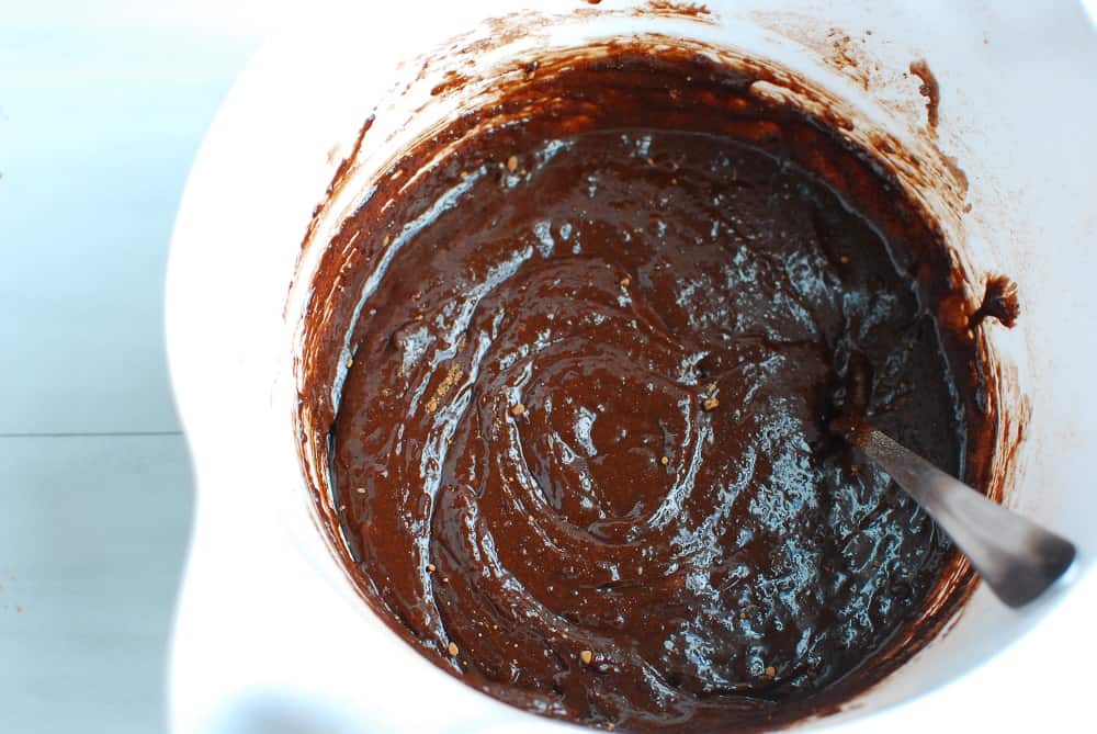 Brownie batter in a white mixing bowl