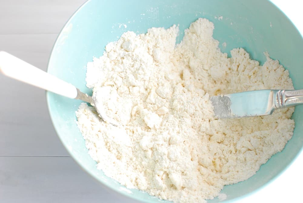 Cutting dairy free butter into flour to make pie crust