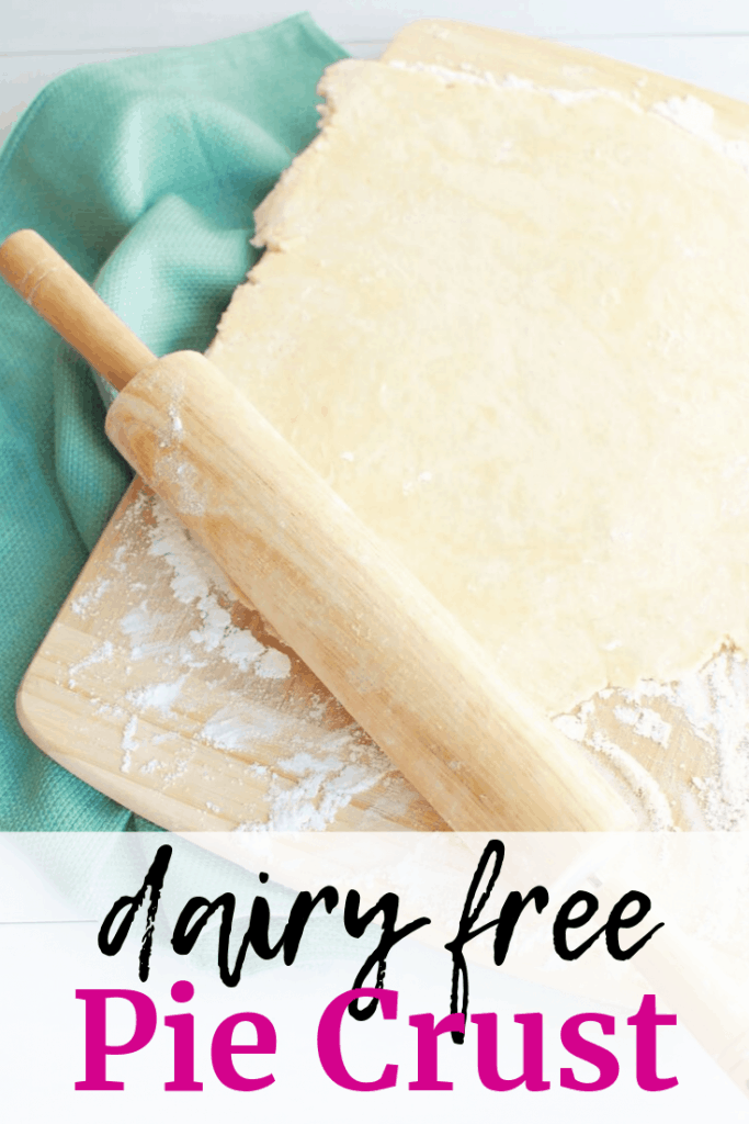 A rolling pin rolling out pie crust on a cutting board.