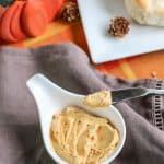 Dairy free whipped honey butter with pumpkin in a white bowl next to a knife