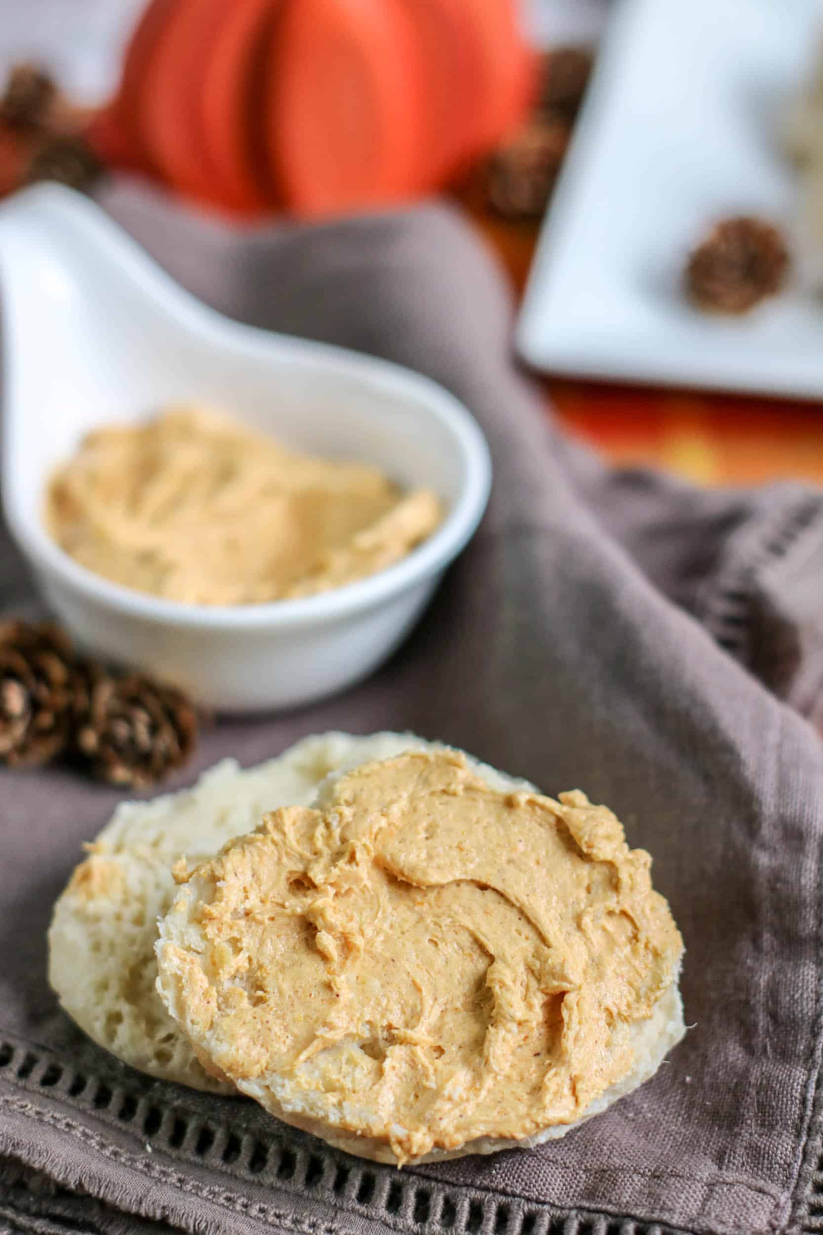 An english muffin topped with dairy free whipped honey butter with pumpkin