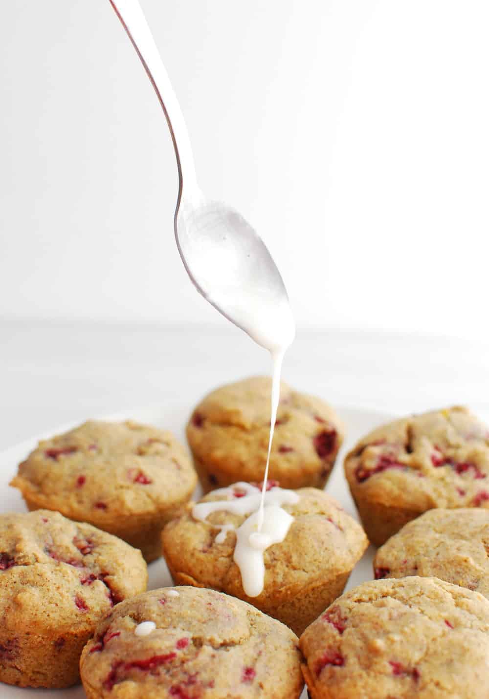 Drizzling lemon glaze on top of muffins