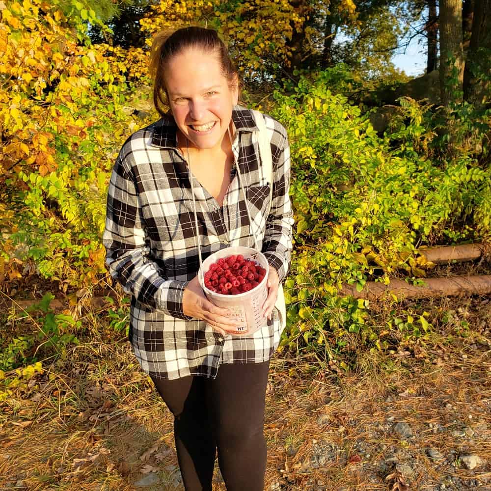 A woman raspberry picking