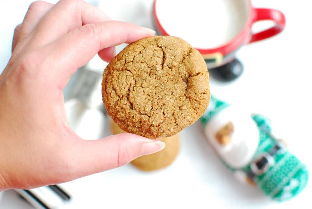 a woman holding a vegan gluten free gingersnap