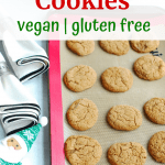 A baking sheet with a silicone mat full of gluten free vegan gingersnap cookies