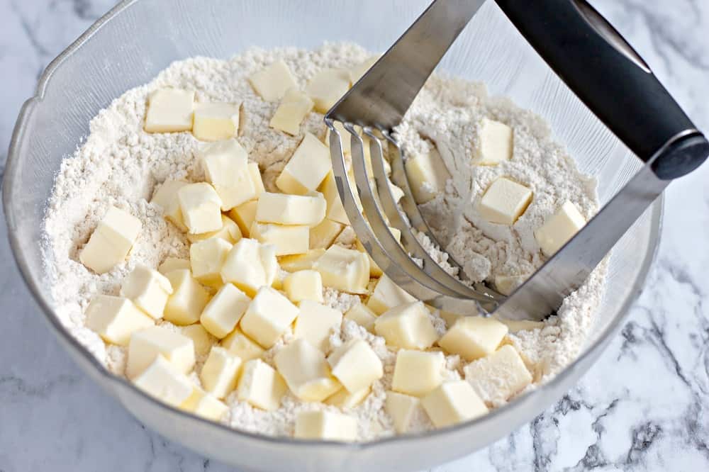 dairy free butter being mixed into flour