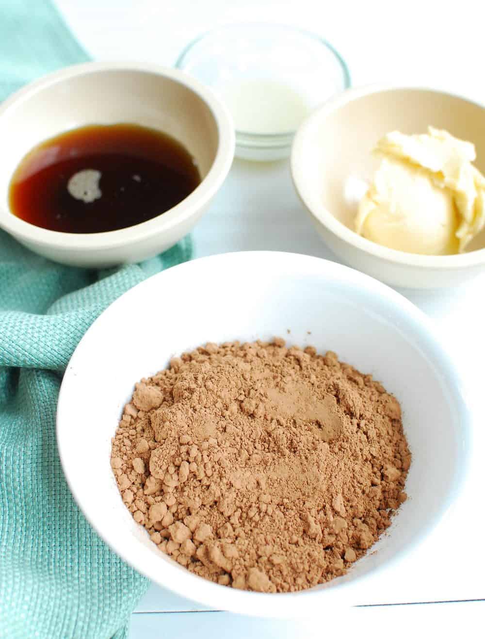 Cocoa powder, maple syrup, and vegan butter in bowls