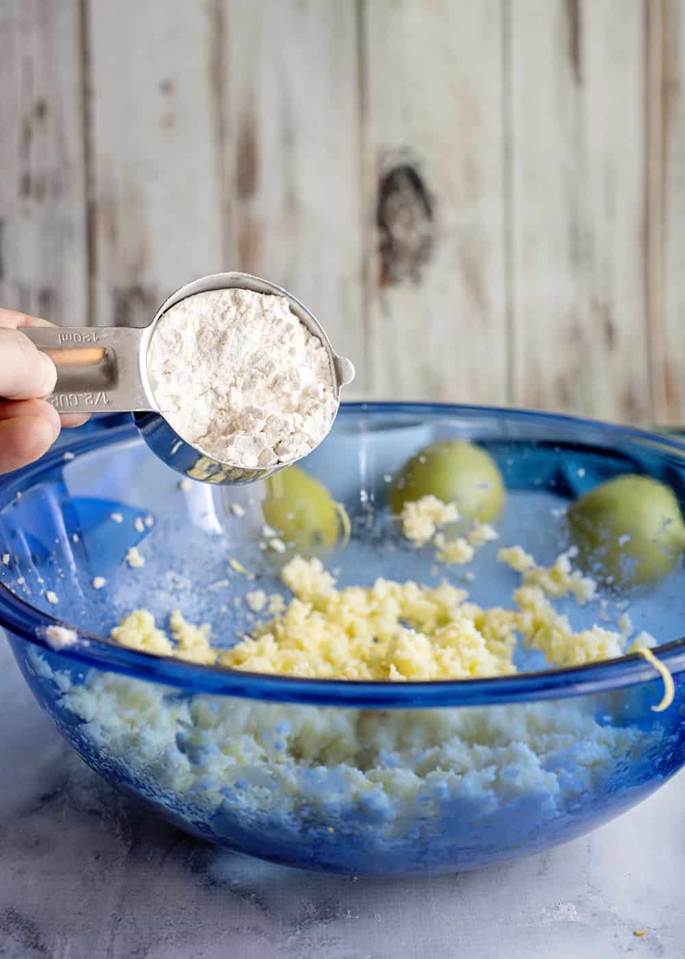 Adding flour to a bowl