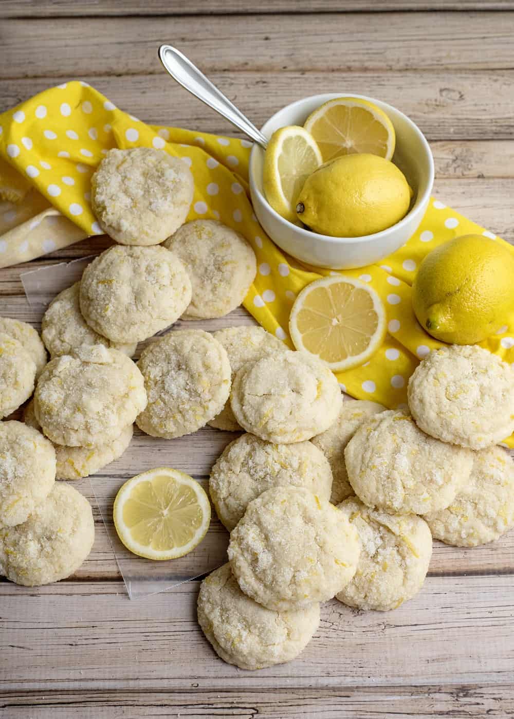 a lot of vegan lemon cookies on a wooden table