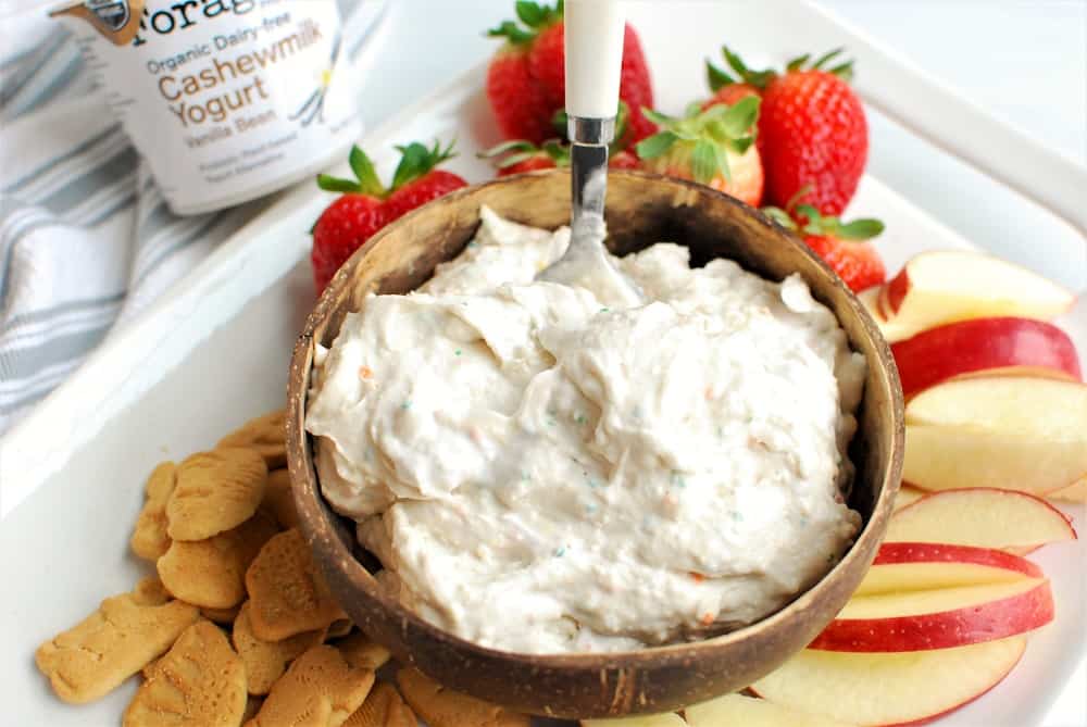 Dairy free cake batter dip next to animal crackers and sliced apples