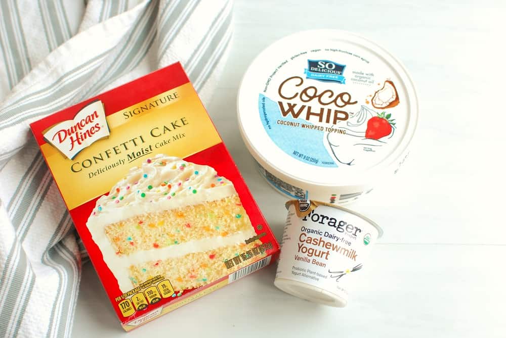 a box of confetti cake mix, a container of cocowhip, and a dairy free yogurt