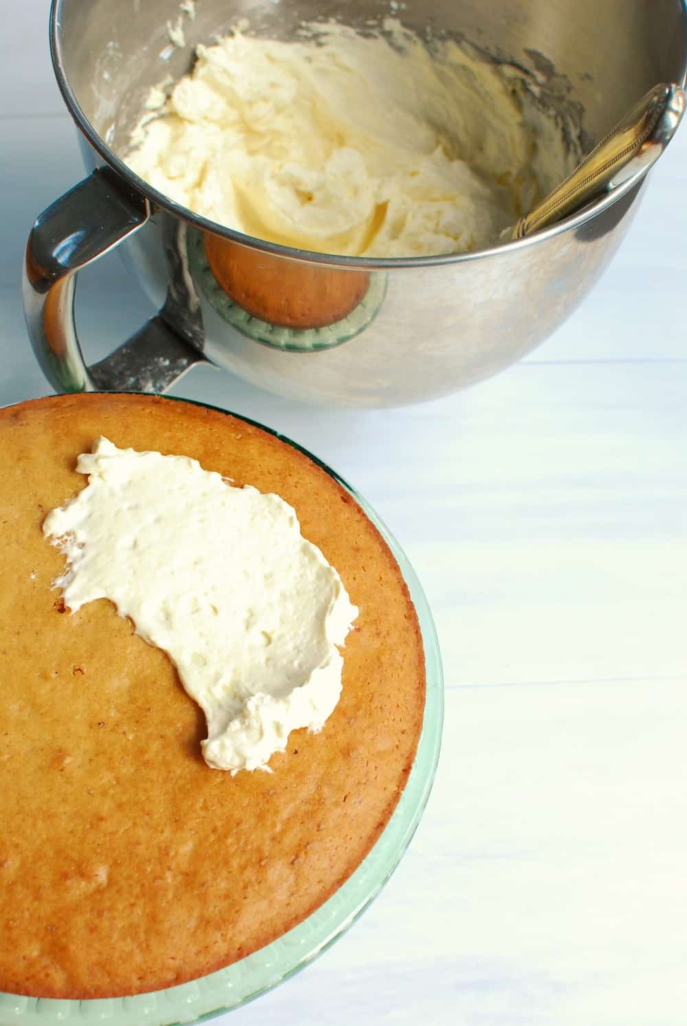 putting a little frosting on a vanilla cake