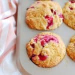 a muffin tin full of cranberry orange muffins