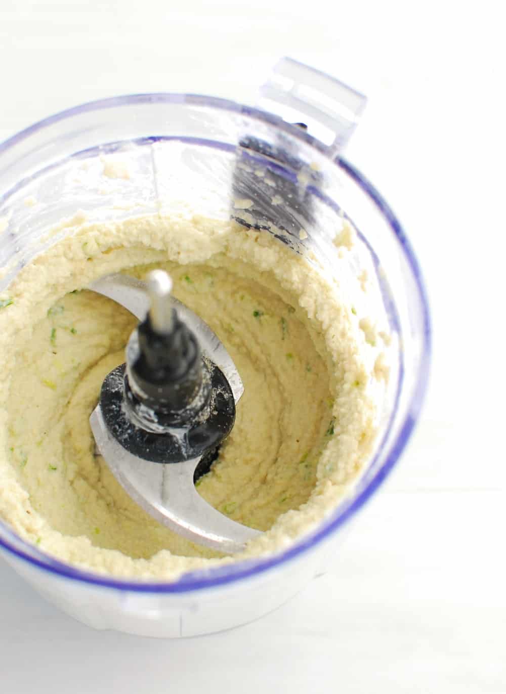 A small food processor filled with just-made dairy free cream cheese.