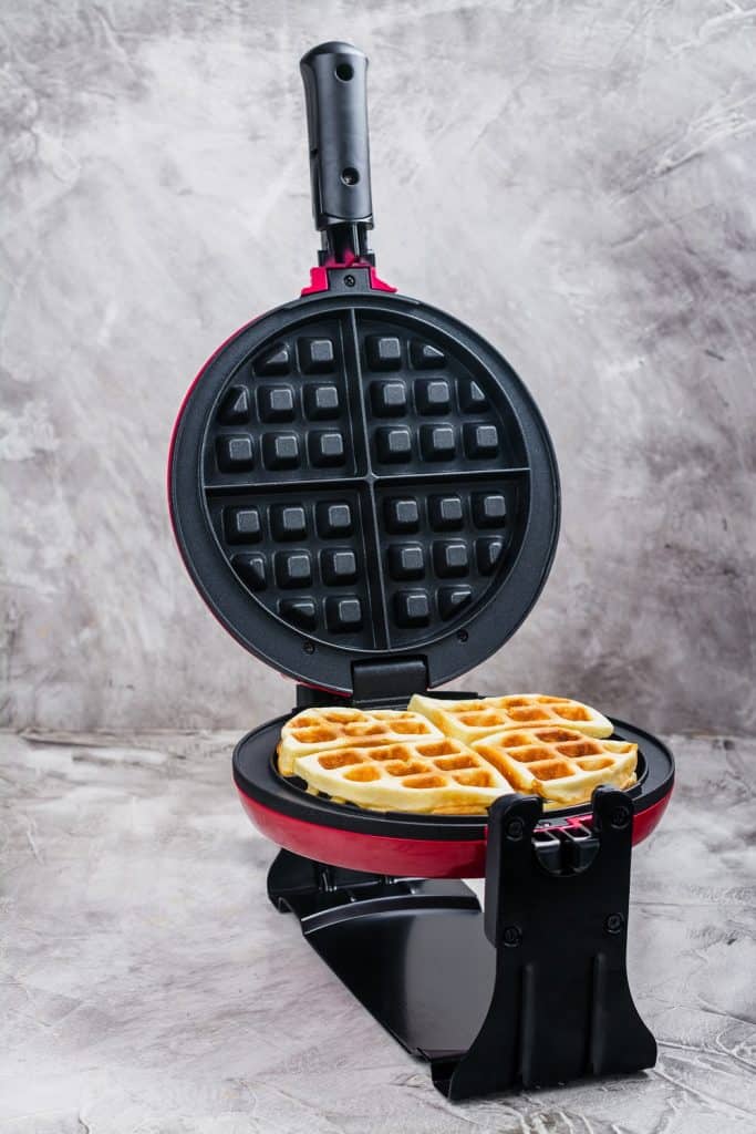 belgian waffle maker with a waffle cooking inside