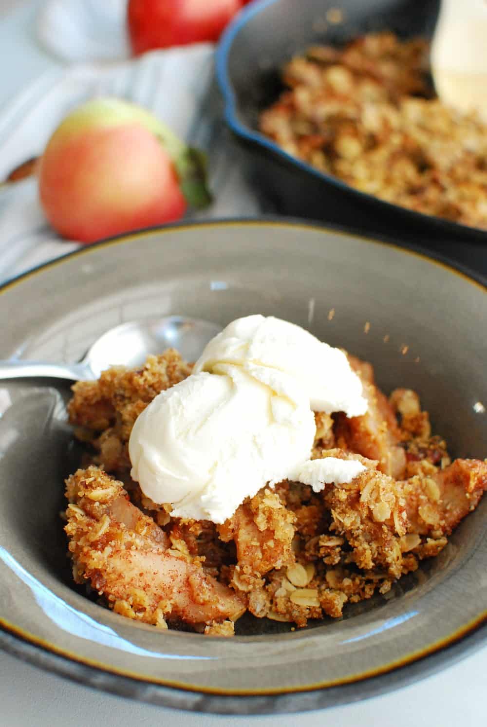 a bowl of bacon apple crisp topped off with dairy free ice cream