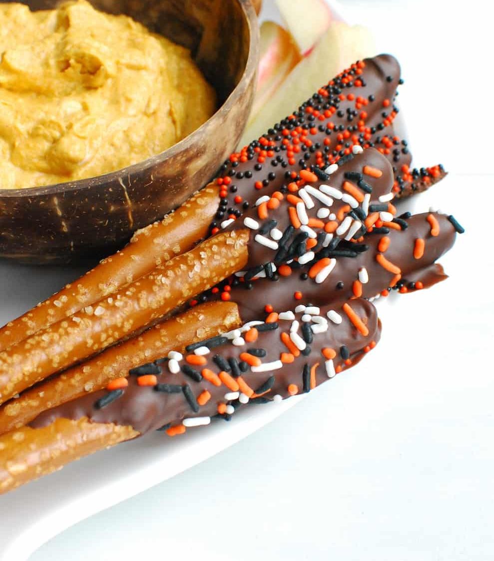 Dark chocolate dipped pretzel rods with Halloween sprinkles