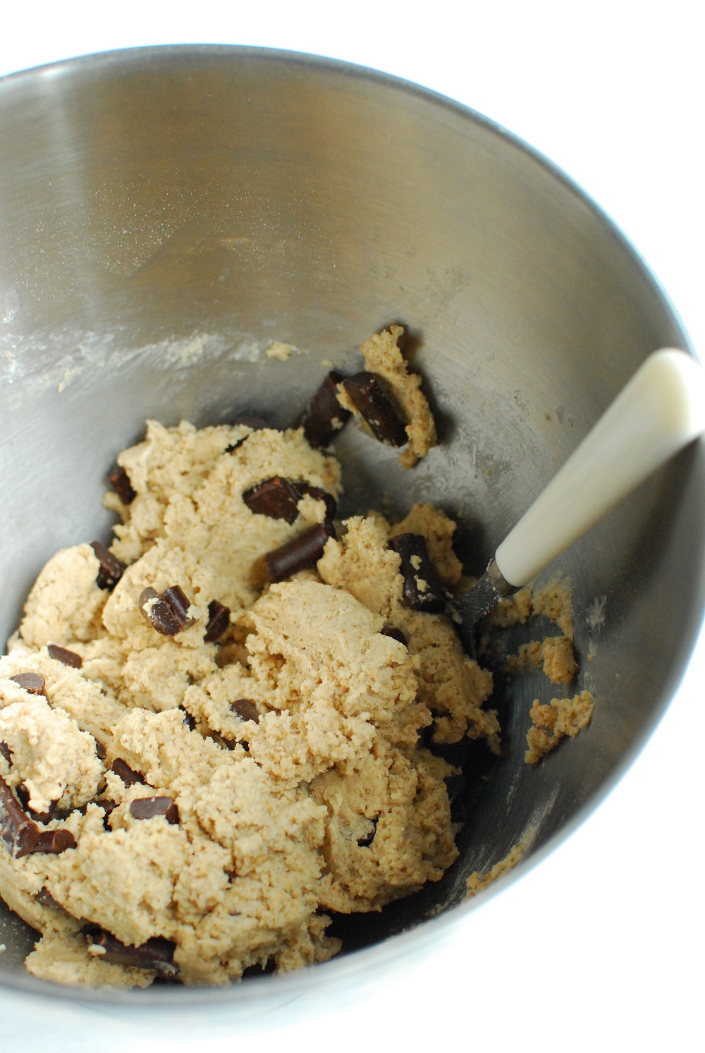 cookie dough in a silver mixing bowl