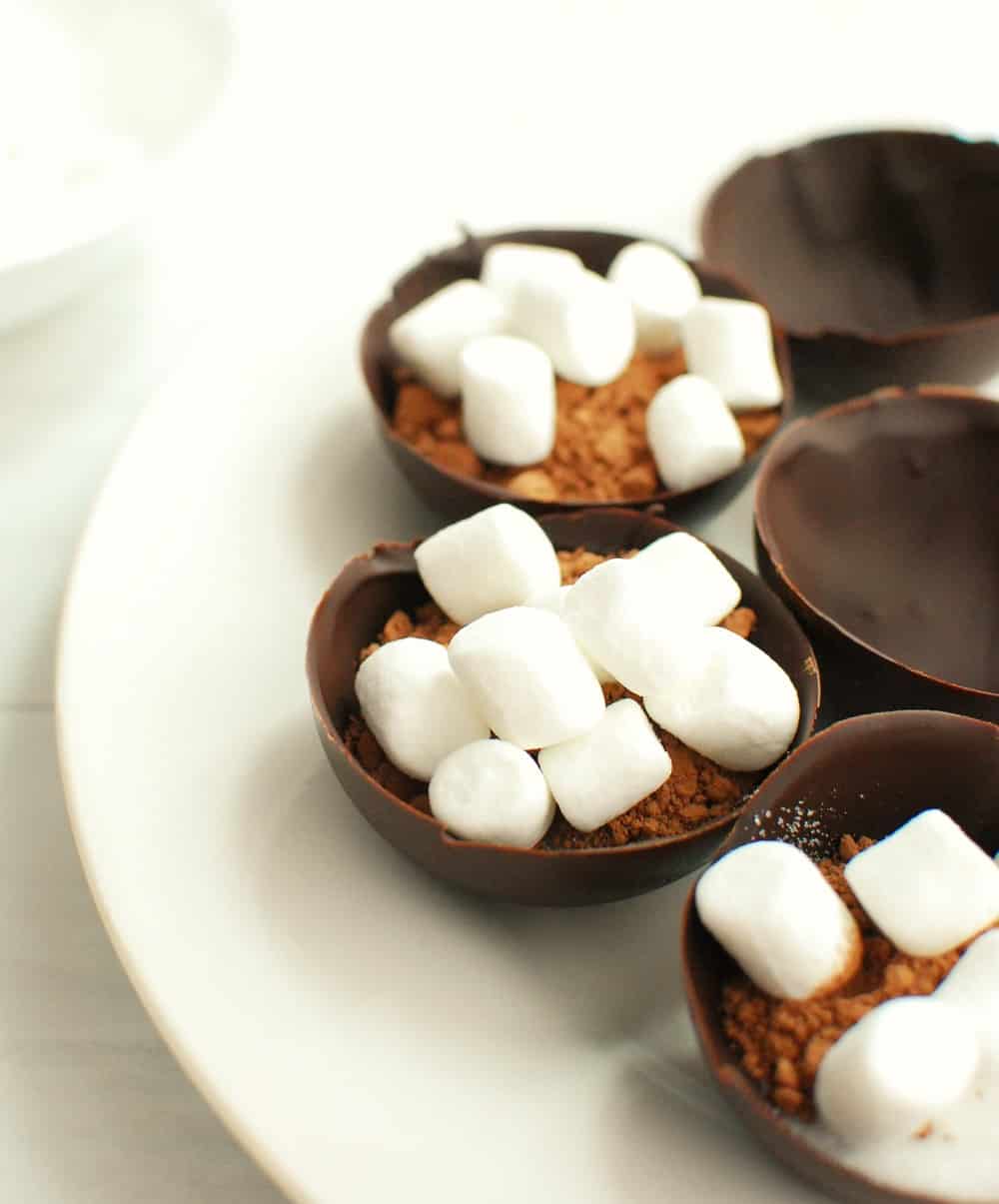 chocolate half circles filled with cocoa, sugar, and mini marshmallows