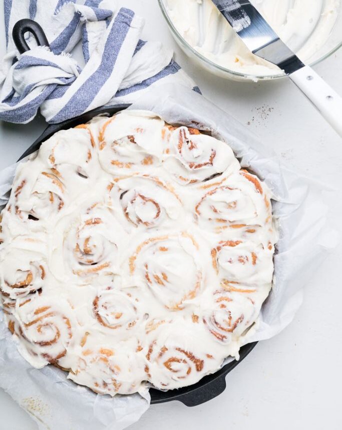 a pan full of frosted dairy free cinnamon rolls for christmas morning