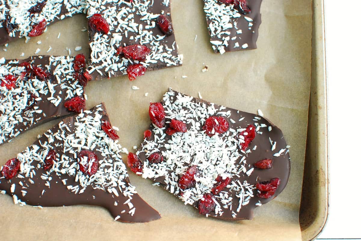 several pieces of dairy free gluten free chocolate bark on a baking sheet