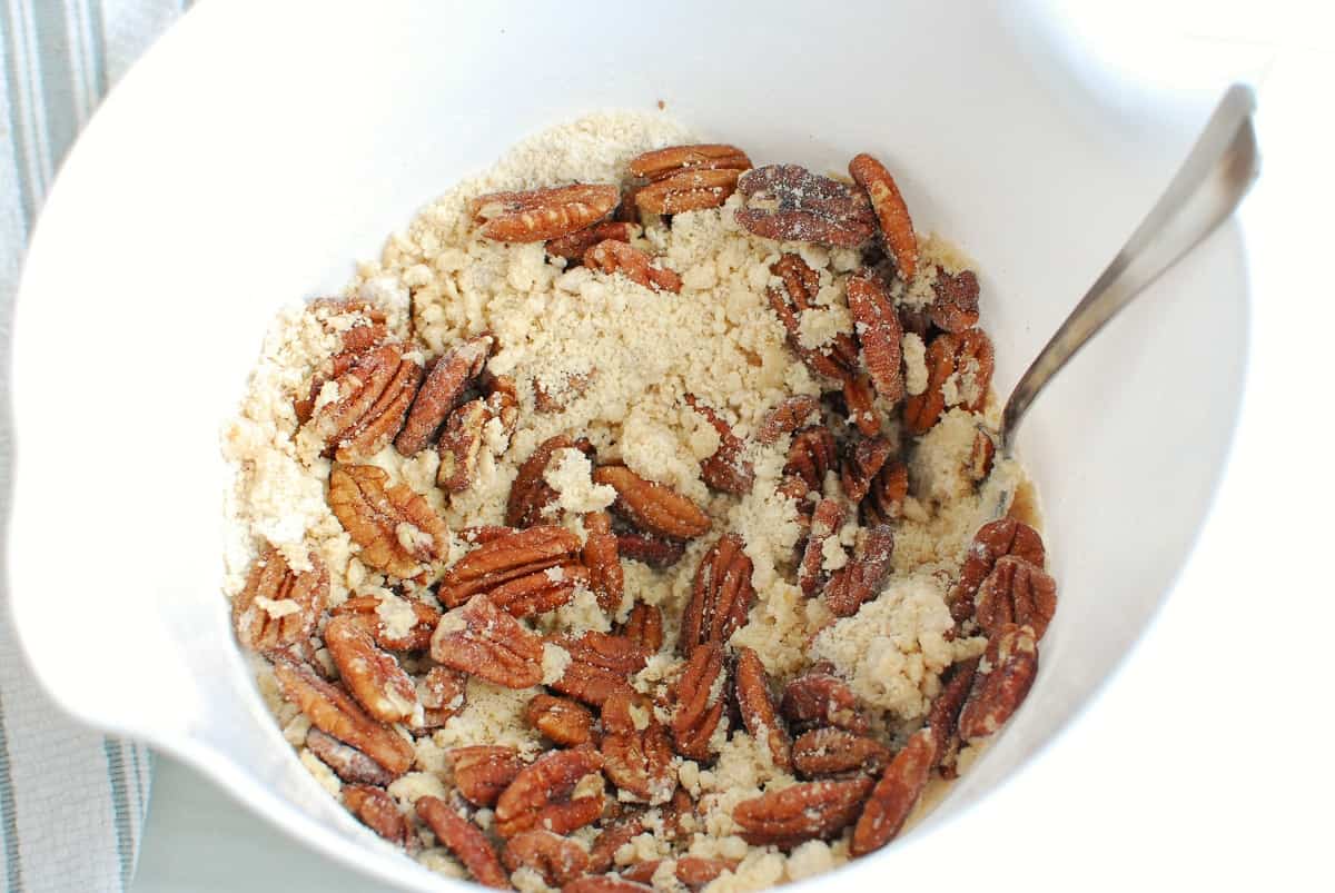 the topping in a bowl made with flour, brown sugar, dairy free butter, salt and pecans