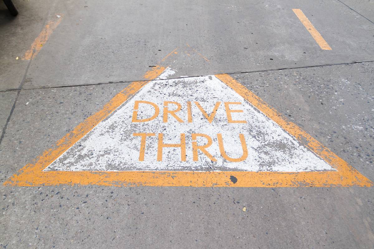 a drive through sign on the road