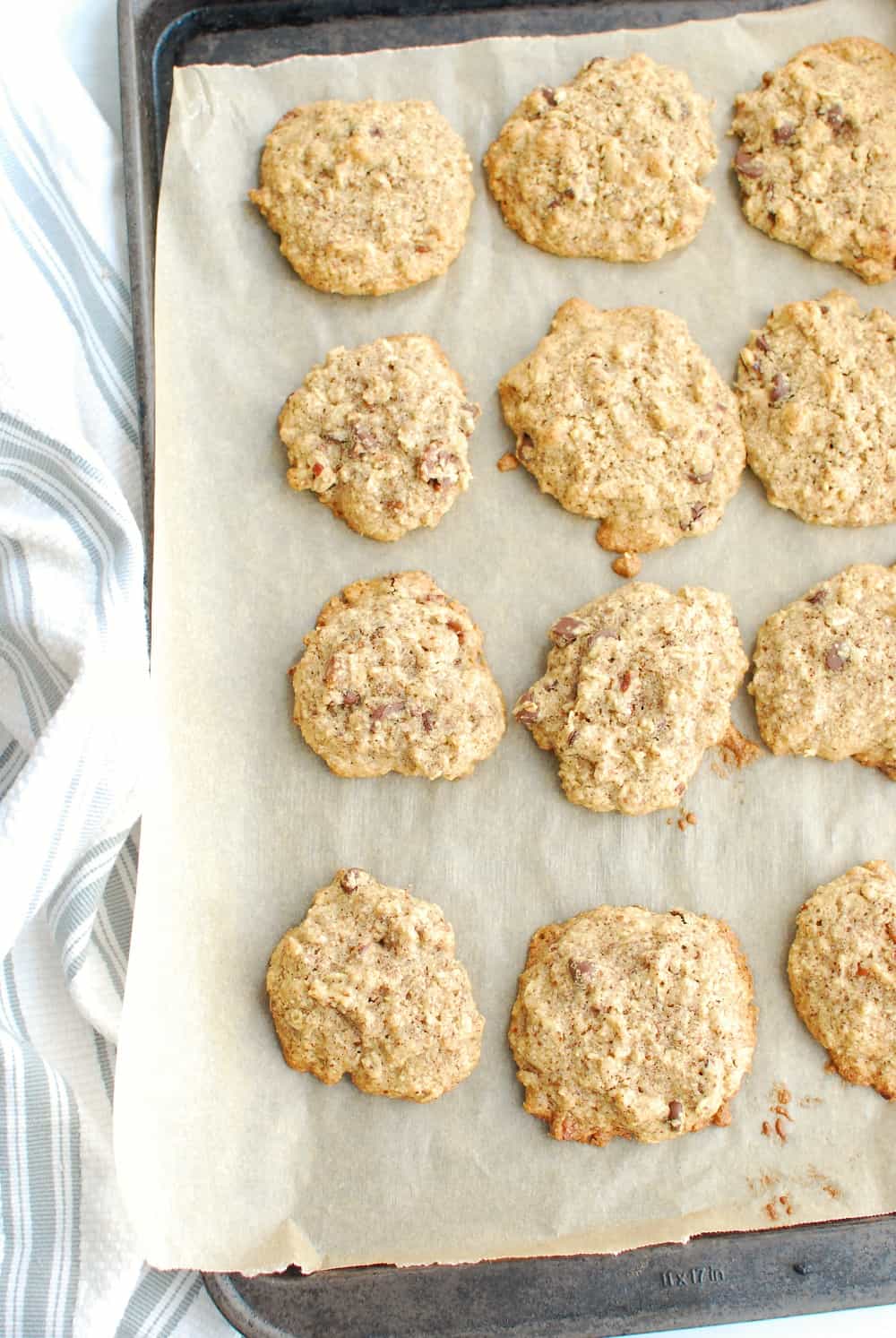A baking sheet with parchment paper full of cookies.