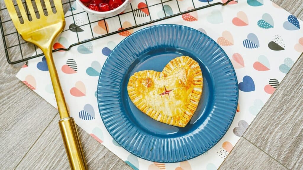 An air fryer cherry hand pie on a blue plate.
