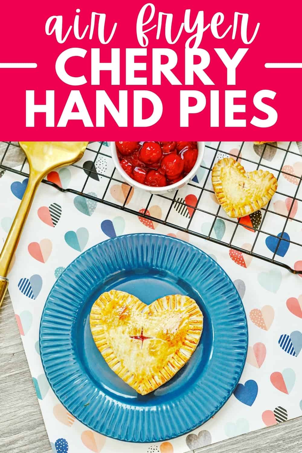 A hand pie on a blue plate on top of a napkin with hearts.