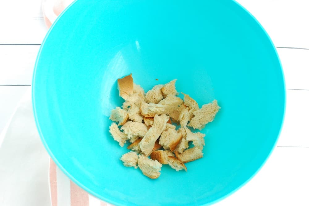 A crumbled piece of bread in a mixing bowl.