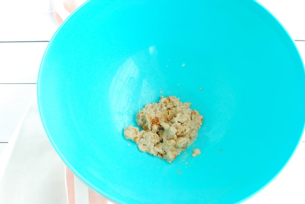 Mashed up bread mixed with oat milk and Worcestershire sauce in a mixing bowl.