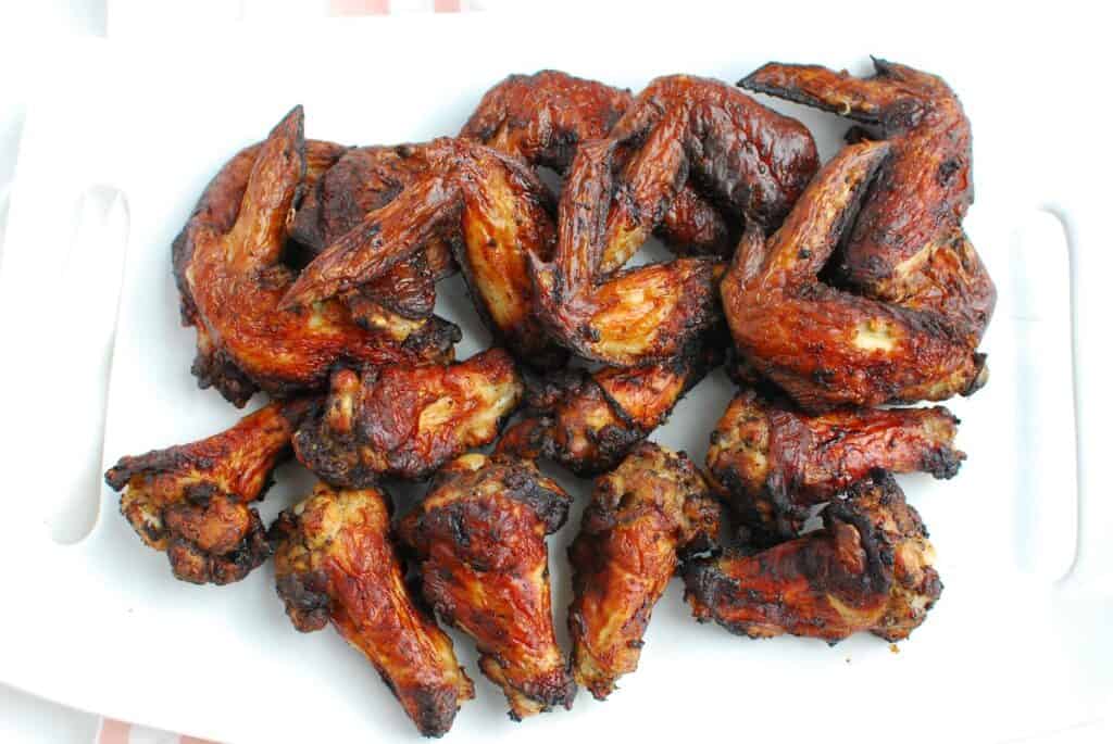 A white platter full of air fryer jerk chicken wings.