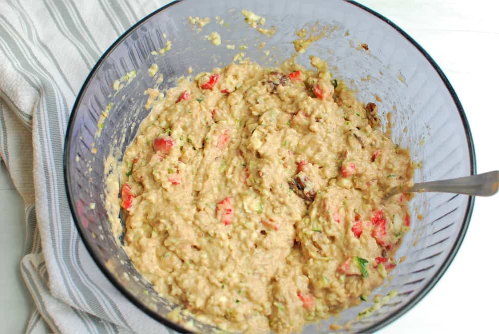 Strawberry zucchini bread batter in a purple bowl.