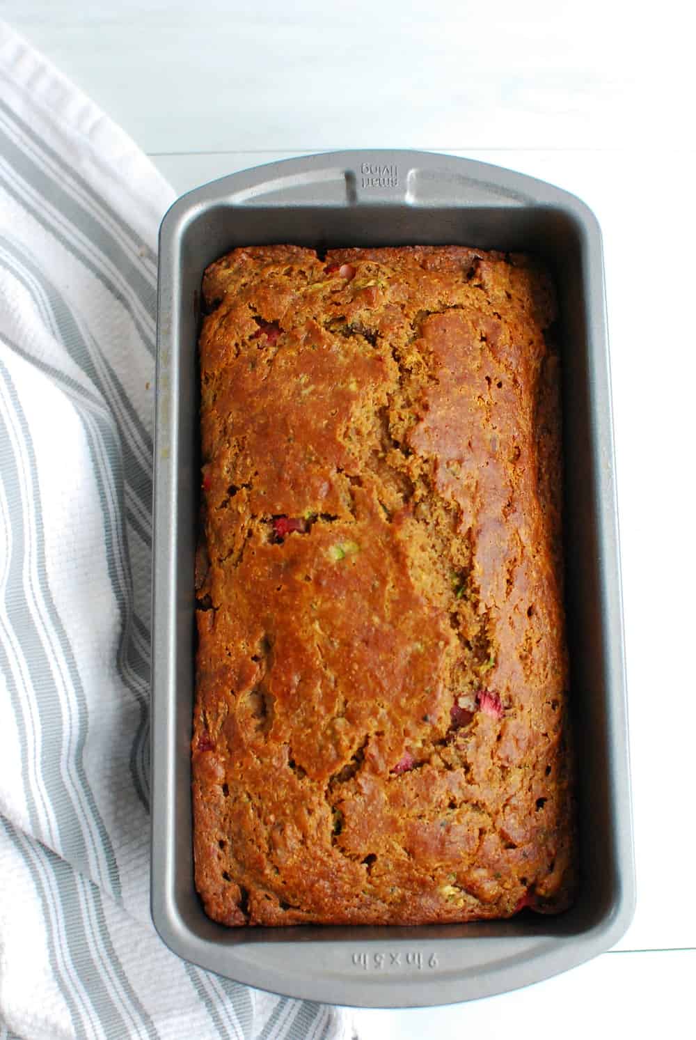 Cooked zucchini strawberry bread still in the loaf pan.