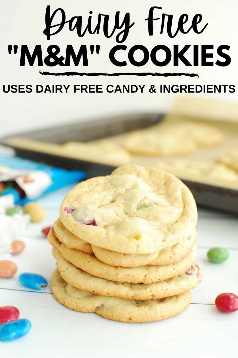 Several dairy free M&M cookies piled on top of each other.