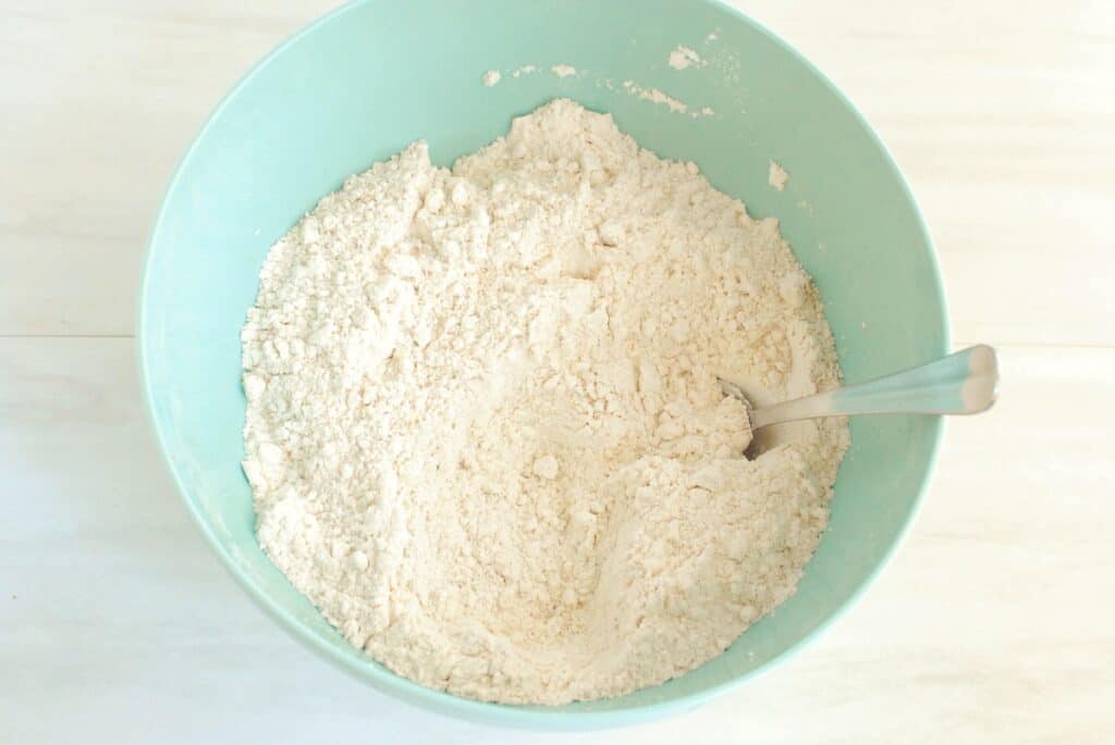 A bowl with cake mix and pumpkin pie spice mixed together.