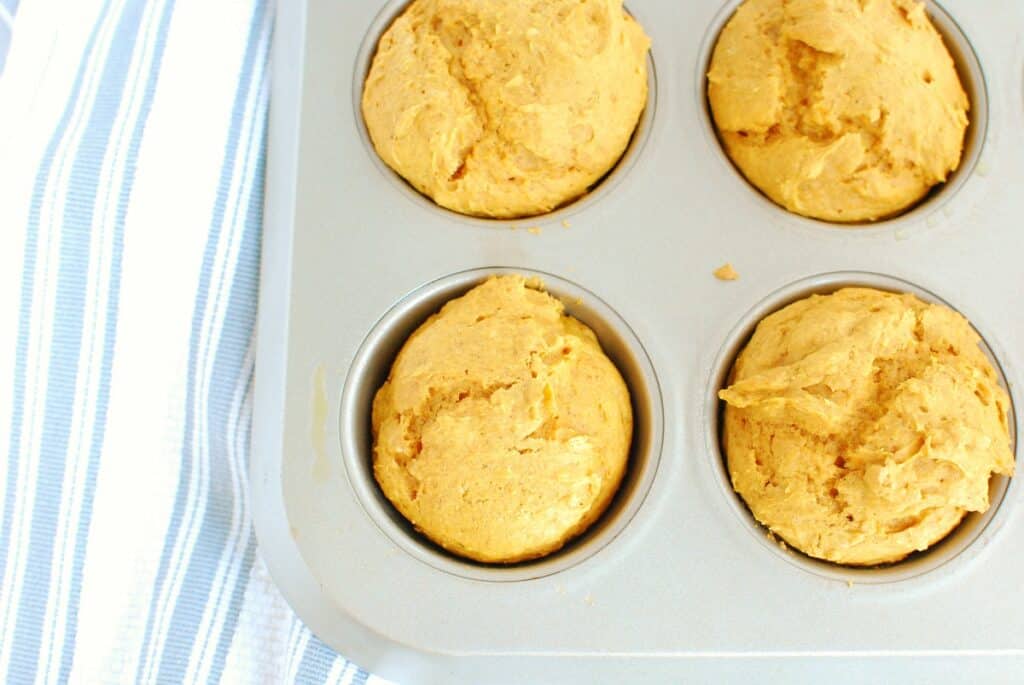 Baked 3 ingredient pumpkin muffins still in the pan.