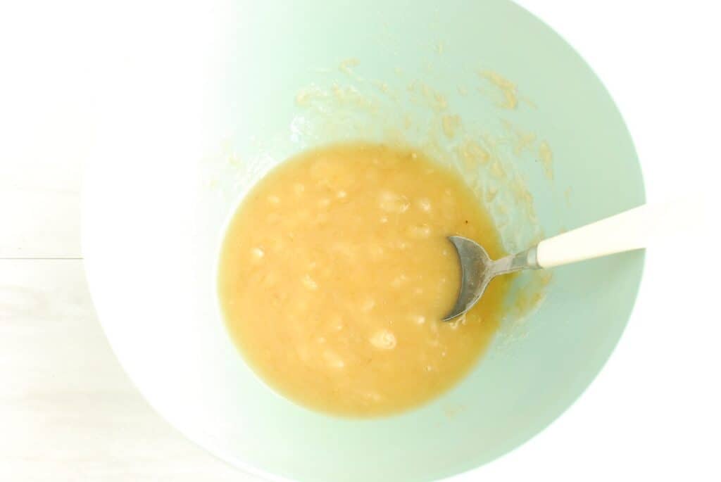 Wet ingredients for pancake batter in a mixing bowl.