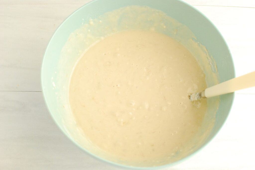 Pancake batter in a blue mixing bowl.