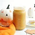 A mason jar full of dairy free pumpkin spice creamer.